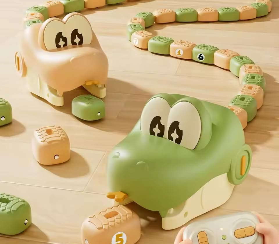 Green and beige Nibbles snakes racing for numbered beans on a wooden floor